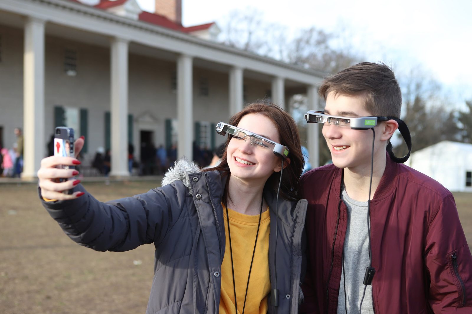 Two visitors wearing the smartglasses on the Mount Vernon estate