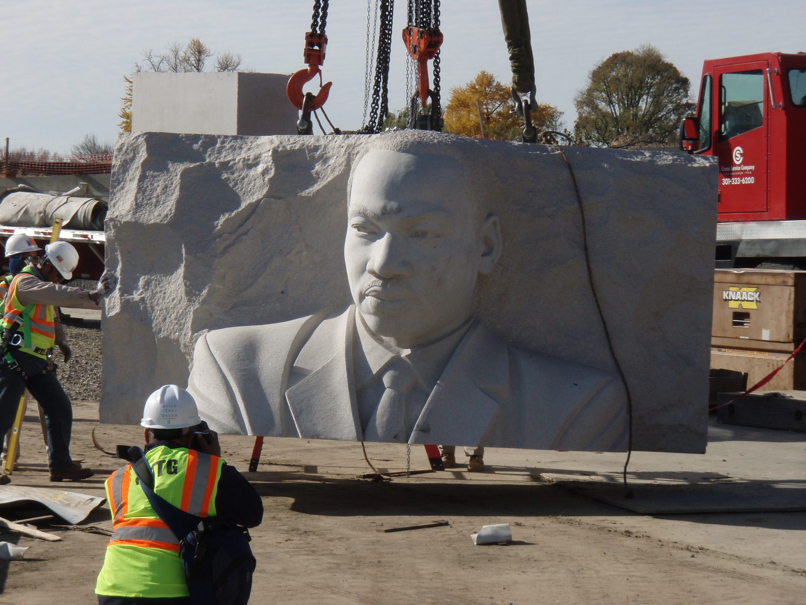 A granite block carved with the likeness of Dr. King is lifted by crane into position on the National Mall site, November 2010