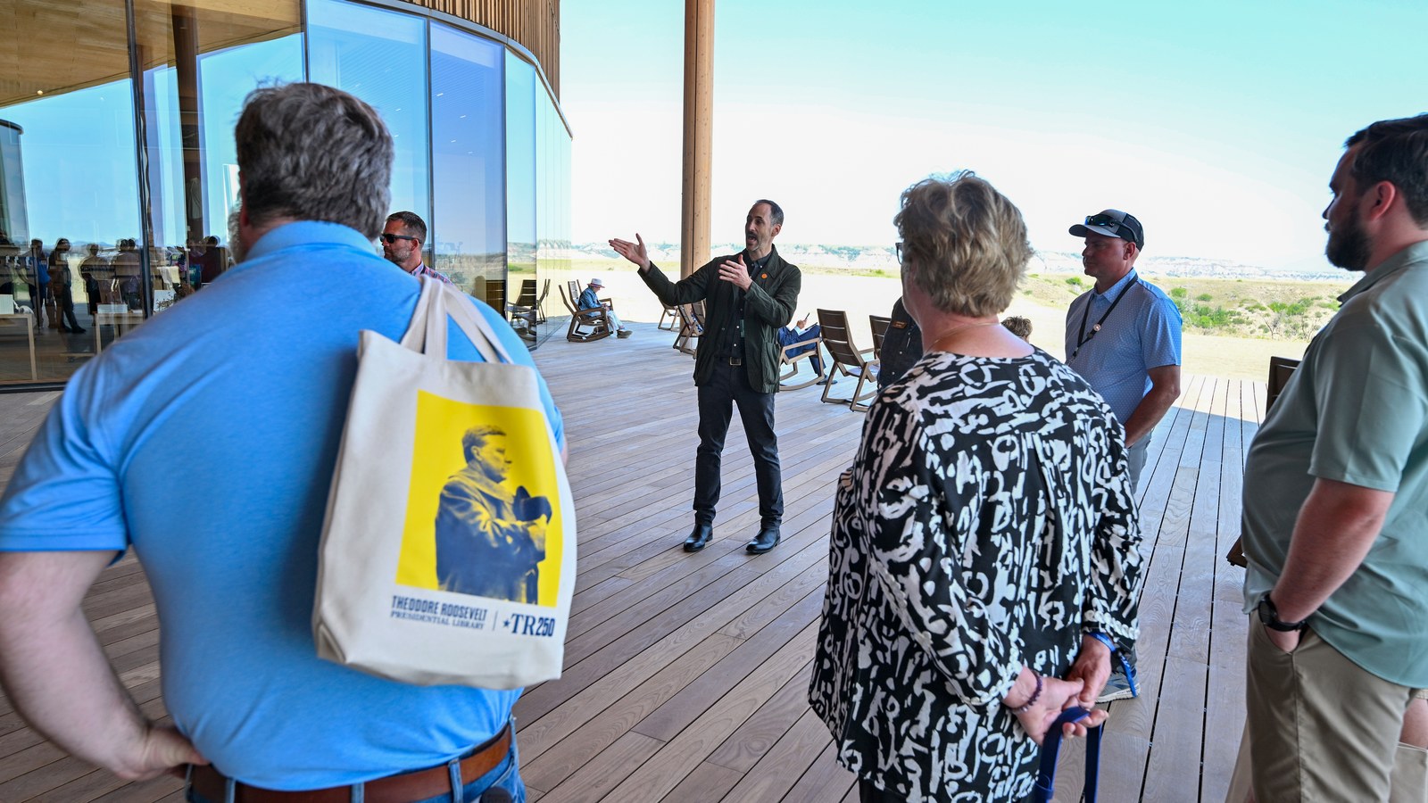A guide addressing visitors on the Library's roof terrace overlooking the Badlands